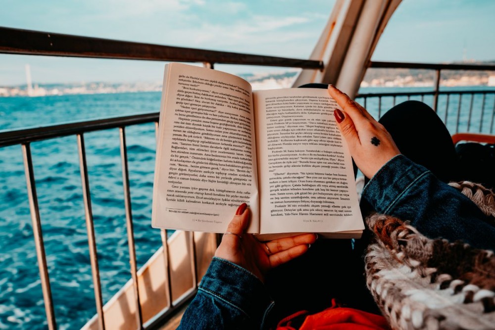 girl_reading_a_book_on_a_boat