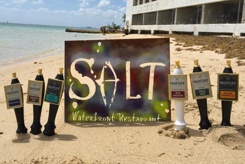 SALT waterfront restaurant sign on the beach